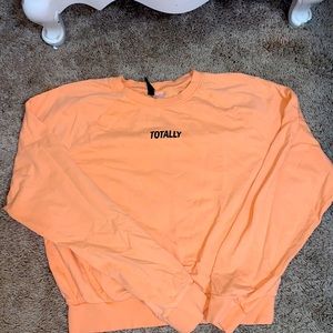This is a light orange crew neck hoodie very comfy
